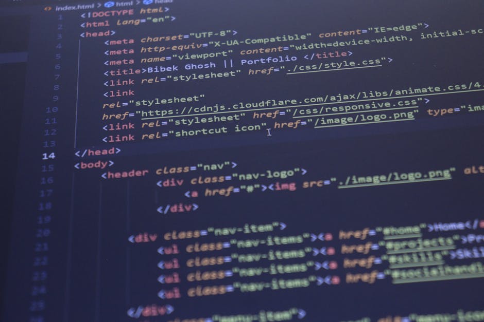 A close-up photograph of a laptop keyboard and screen displaying lines of green and white source code, positioned on a wooden desk. To the right of the laptop, there is a ceramic coffee mug with a bei